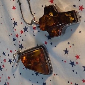 Set of 2 amber pendants, cross and triangle, set in silver